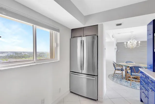 a kitchen with stainless steel appliances a refrigerator and a table