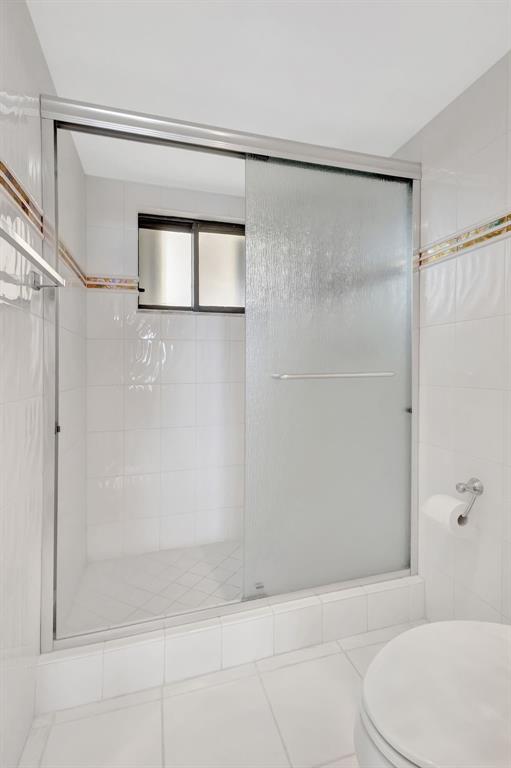 300 Ocean Trail Way, Unit 907 Jupiter, FL 33477 - Photo 18 of 42 a bathroom with a shower and a toilet