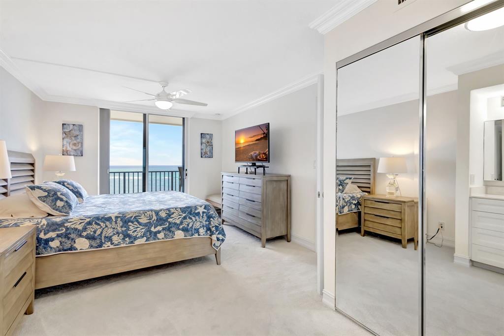 300 Ocean Trail Way, Unit 907 Jupiter, FL 33477 - Photo 19 of 42 a bedroom with furniture and large window