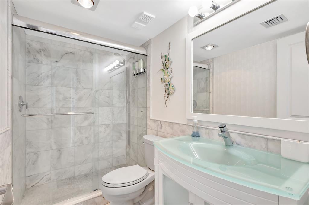 300 Ocean Trail Way, Unit 907 Jupiter, FL 33477 - Photo 29 of 42 a bathroom with a sink toilet and shower