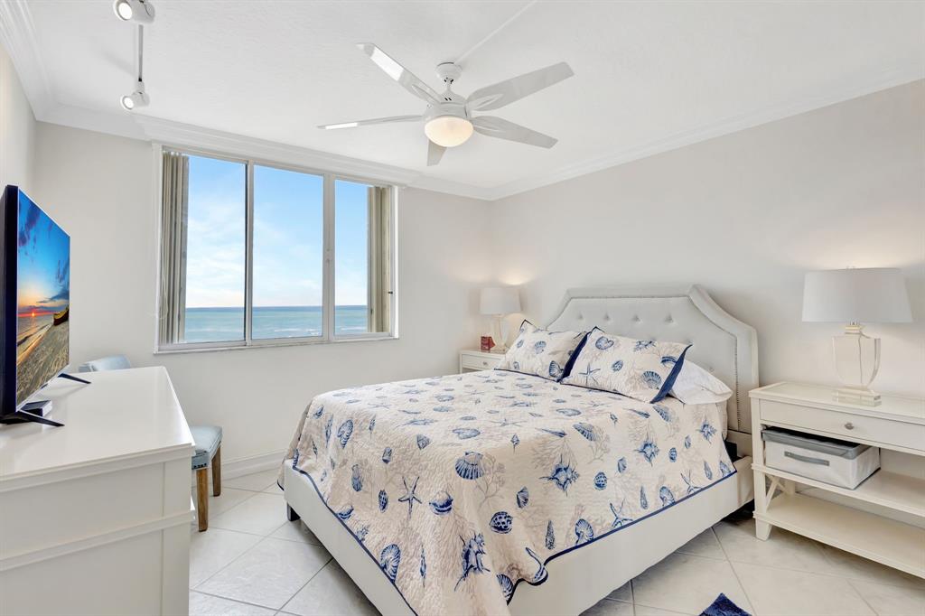 300 Ocean Trail Way, Unit 907 Jupiter, FL 33477 - Photo 30 of 42 a bedroom with a bed and a flat screen tv