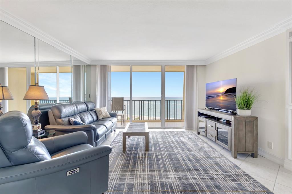 300 Ocean Trail Way, Unit 907 Jupiter, FL 33477 - Photo 6 of 42 a living room with furniture and a flat screen tv