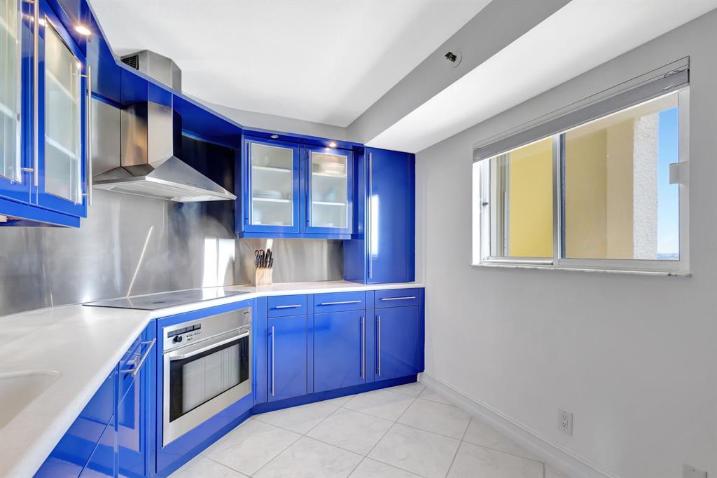 300 Ocean Trail Way, Unit 907 Jupiter, FL 33477 - Photo 9 of 42 a kitchen with stainless steel appliances granite countertop a stove and a sink