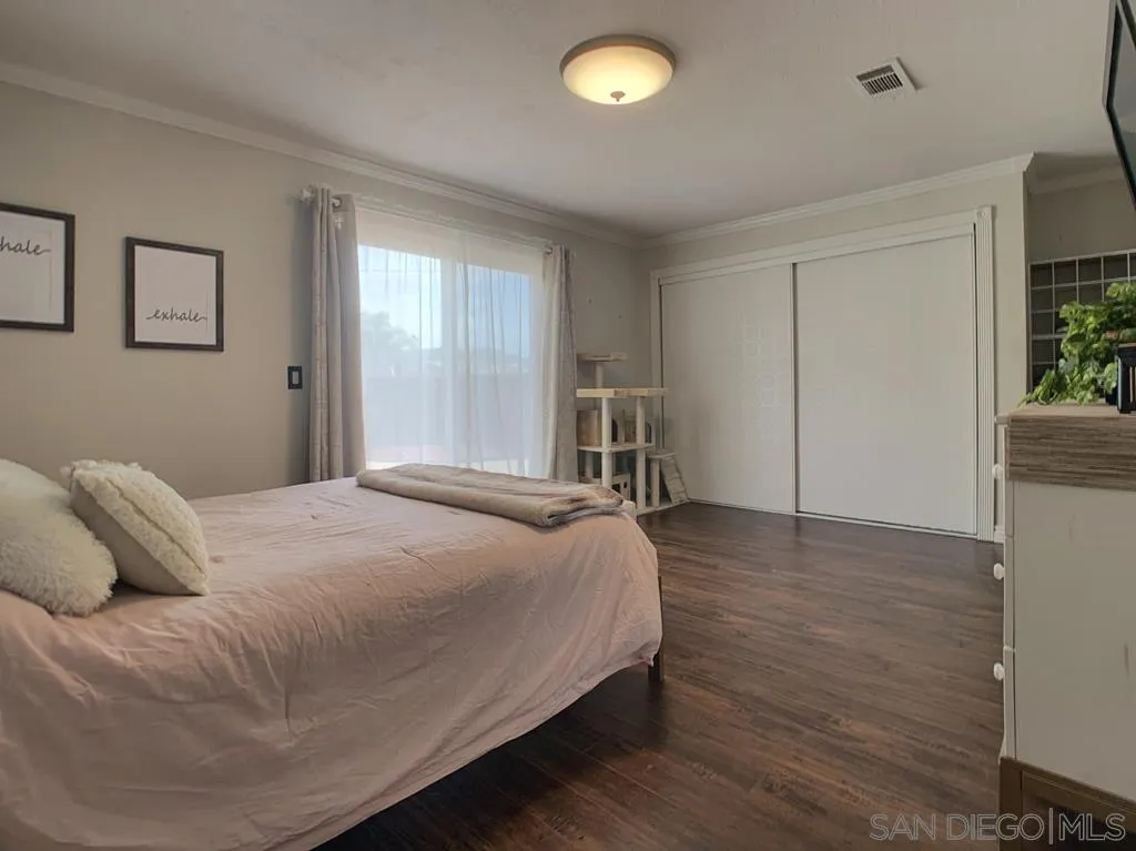 14416 Springvale Street Poway, CA 92064 - Photo 8 of 18 a bedroom with a bed and a potted plant