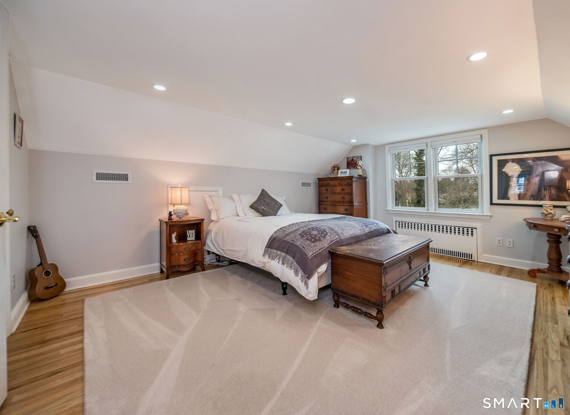 59 Forest Hill Road North Haven, CT 06473 - Photo 25 of 35 a living room with a bed furniture and a flat screen tv