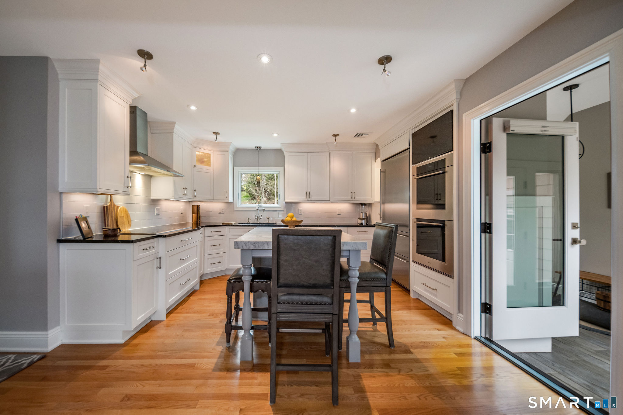 59 Forest Hill Road North Haven, CT 06473 - Photo 4 of 35 a kitchen with stainless steel appliances granite countertop wooden floor a refrigerator a sink and a stove