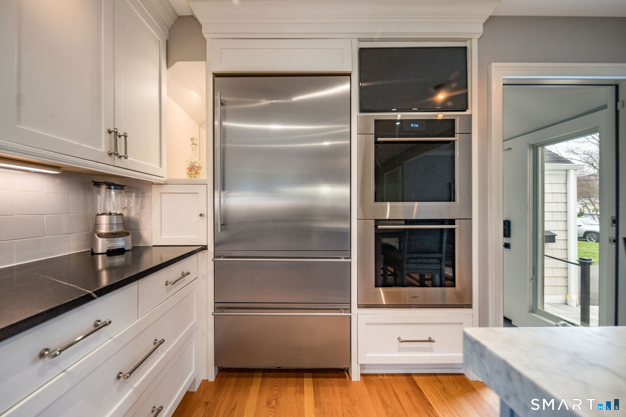59 Forest Hill Road North Haven, CT 06473 - Photo 7 of 35 a kitchen with kitchen island granite countertop a refrigerator and a sink