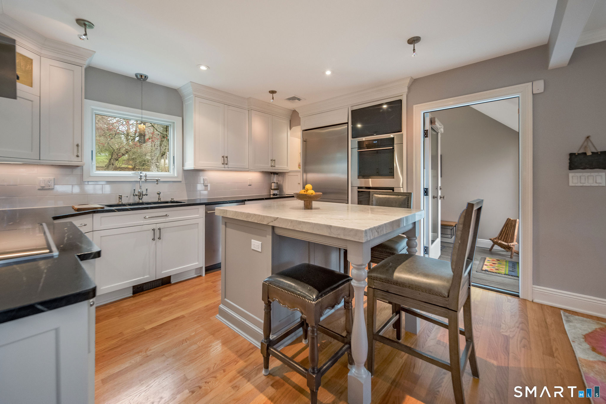 59 Forest Hill Road North Haven, CT 06473 - Photo 8 of 35 a kitchen with a table chairs sink and cabinets