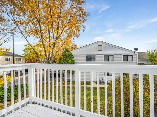 a view of a white house with a large window