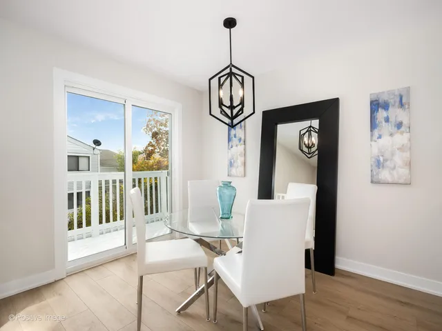 a view of dining room with wooden floor and windows