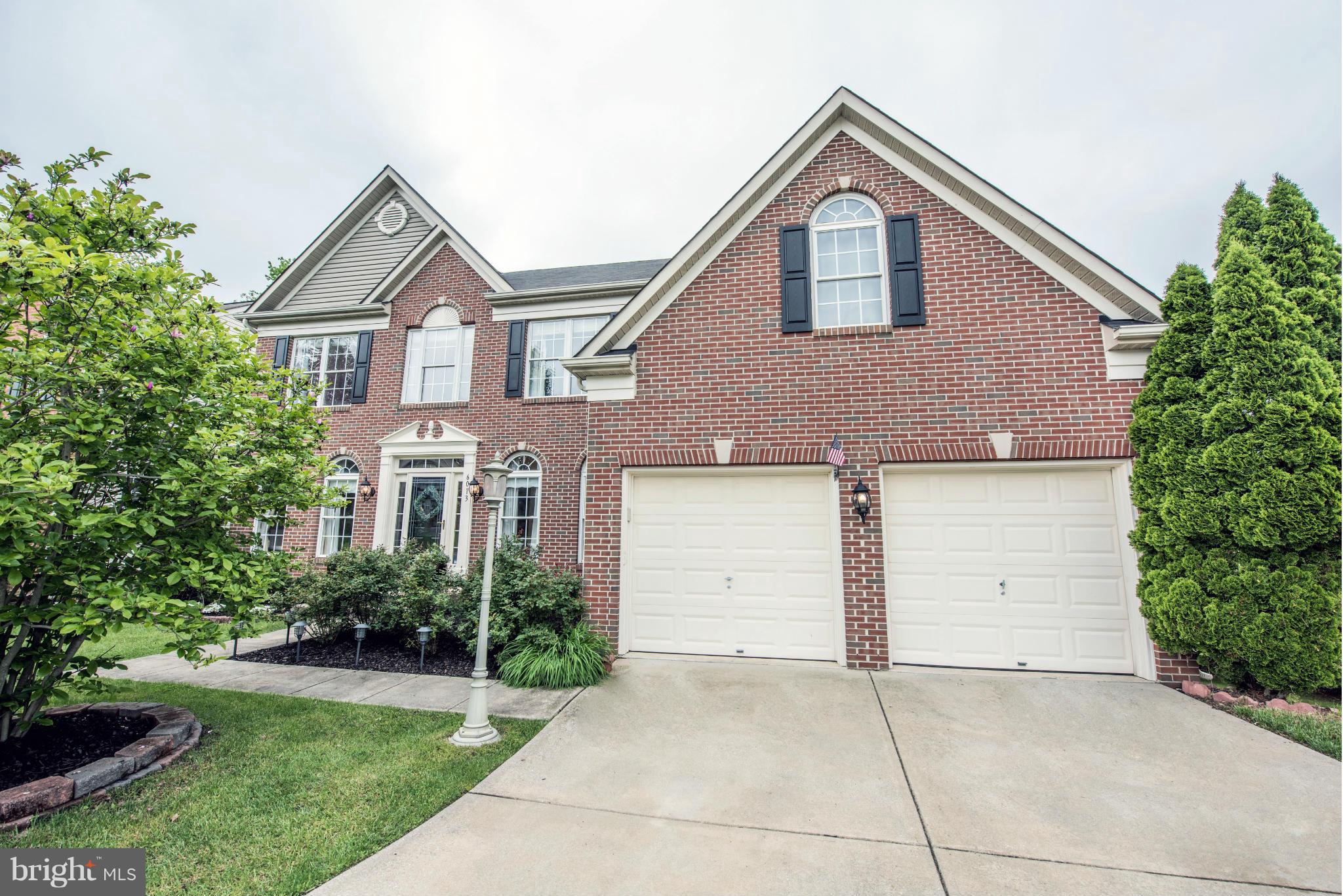 6013 Sandy Ridge Elkridge, MD 21075 - Photo 1 of 30 a front view of a house with a yard and garage
