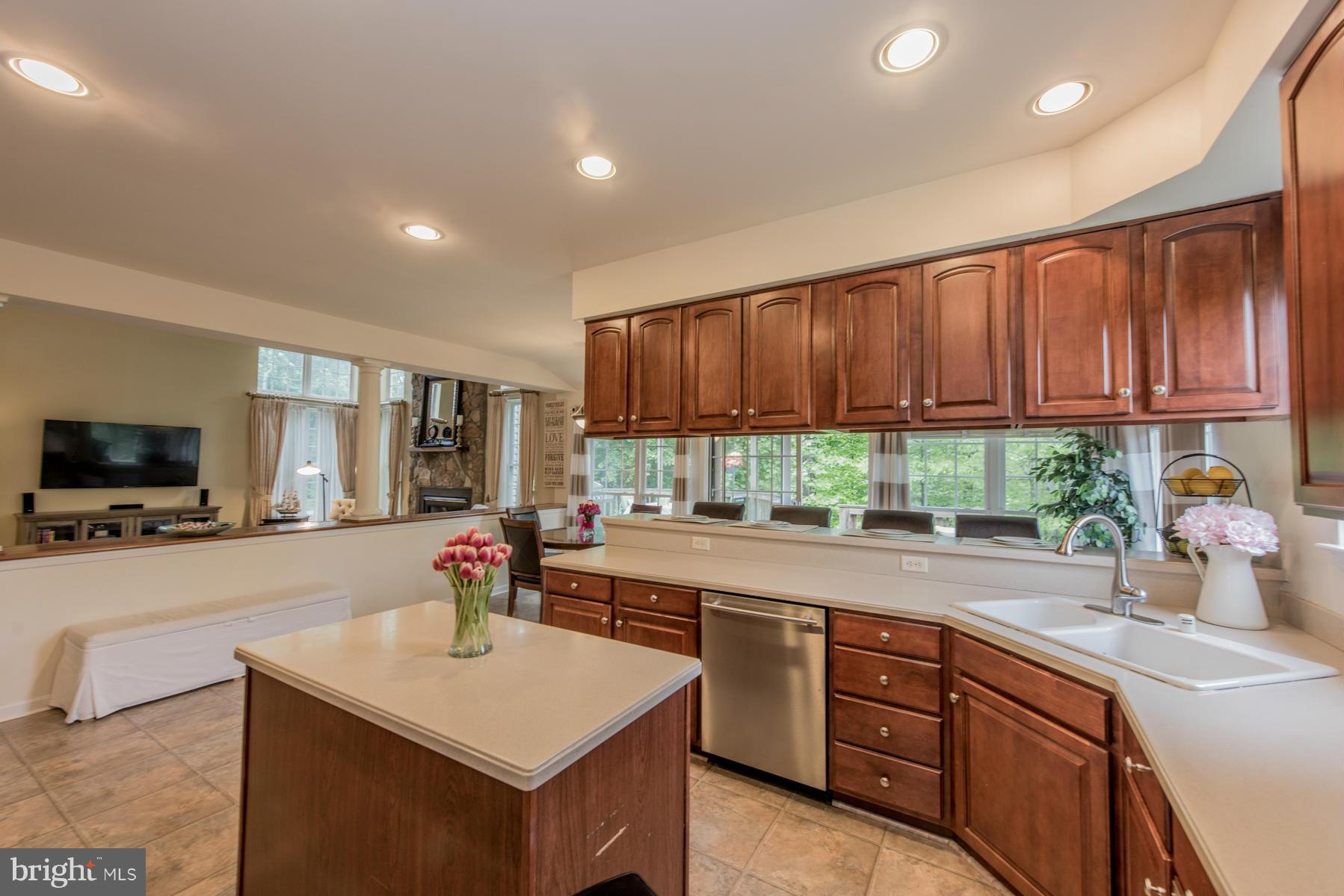 6013 Sandy Ridge Elkridge, MD 21075 - Photo 11 of 30 a kitchen with a sink a counter top space and living room view