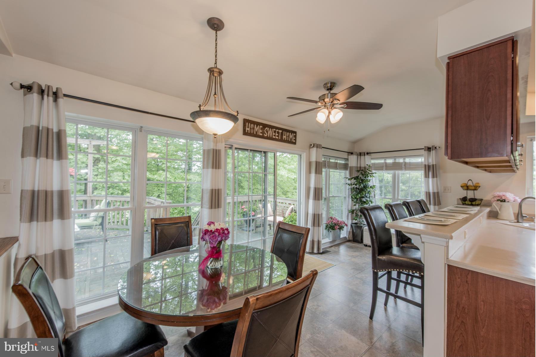 6013 Sandy Ridge Elkridge, MD 21075 - Photo 13 of 30 a dining room with furniture a chandelier and wooden floor