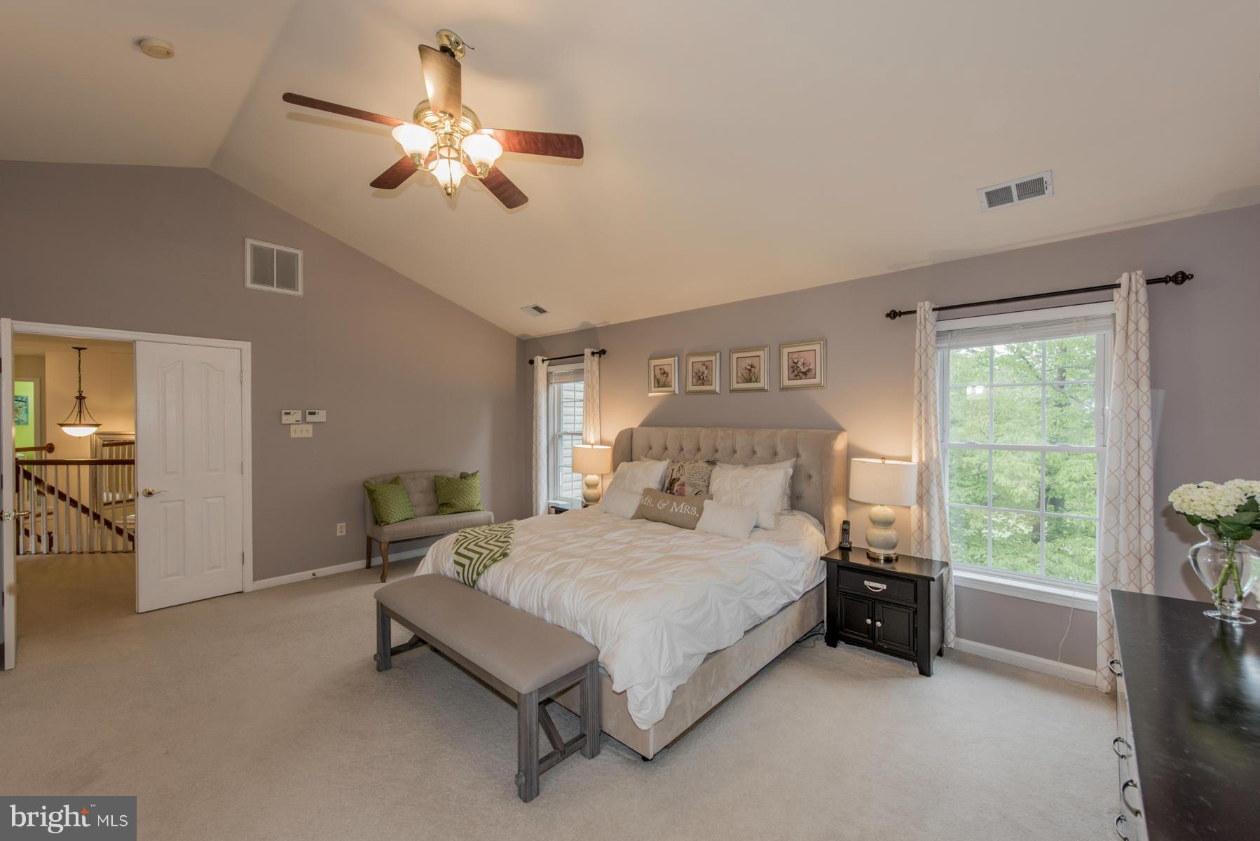 6013 Sandy Ridge Elkridge, MD 21075 - Photo 18 of 30 a bedroom with a bed and a chandelier
