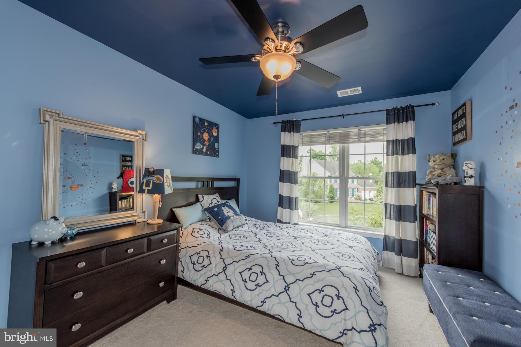 6013 Sandy Ridge Elkridge, MD 21075 - Photo 22 of 30 a bedroom with a large bed and a chandelier