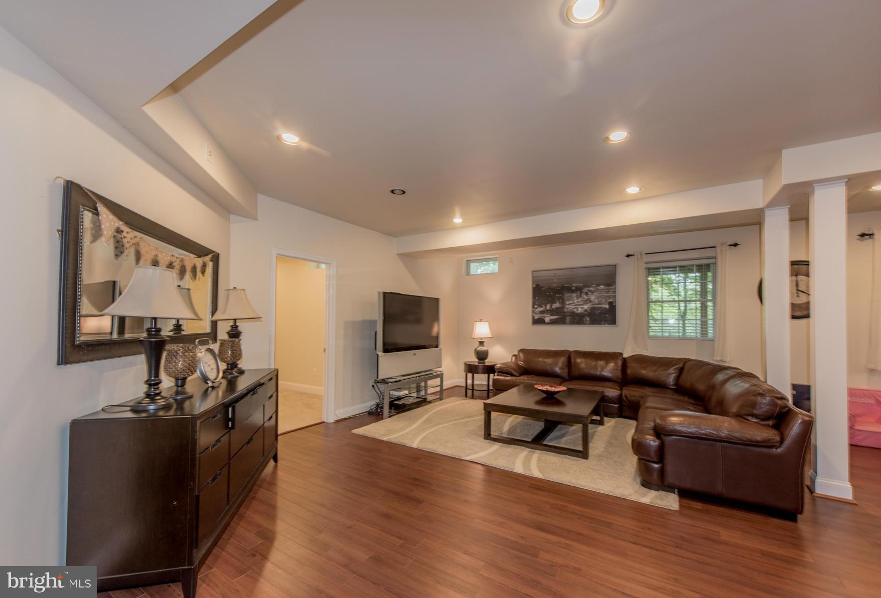 6013 Sandy Ridge Elkridge, MD 21075 - Photo 23 of 30 a living room with furniture flat screen tv and wooden floor