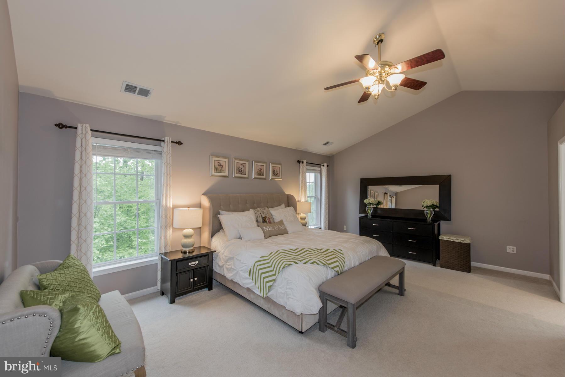 6013 Sandy Ridge Elkridge, MD 21075 - Photo 4 of 30 a bedroom with a bed and a chandelier