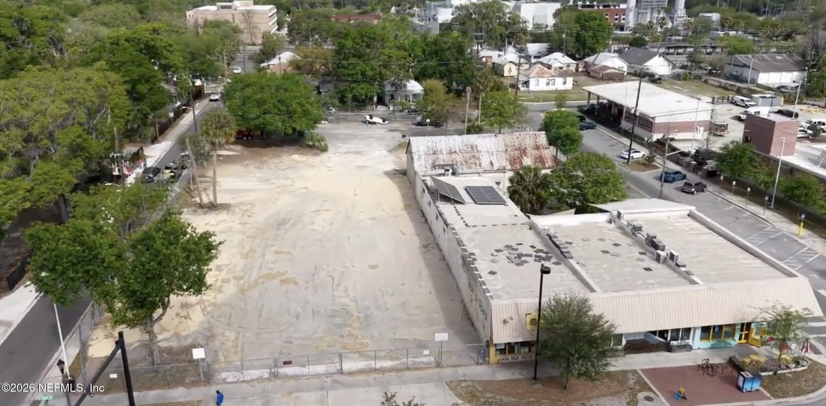 427 South Main Street Gainesville, FL 32601 - Photo 3 of 11 an aerial view of a house with a yard and wooden fence