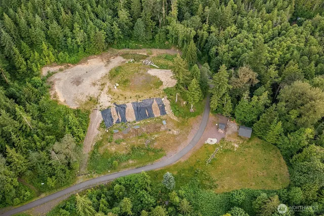 an aerial view of a house with yard swimming pool and outdoor seating