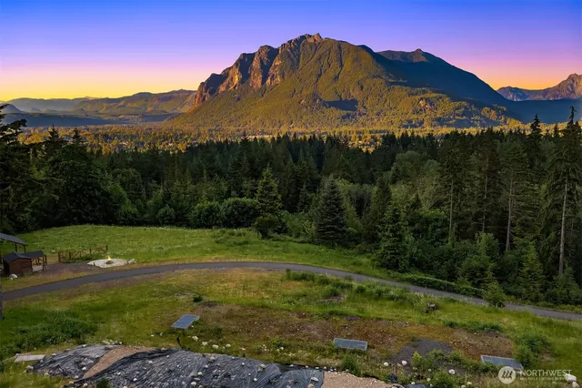 a view of a big yard with table and chairs
