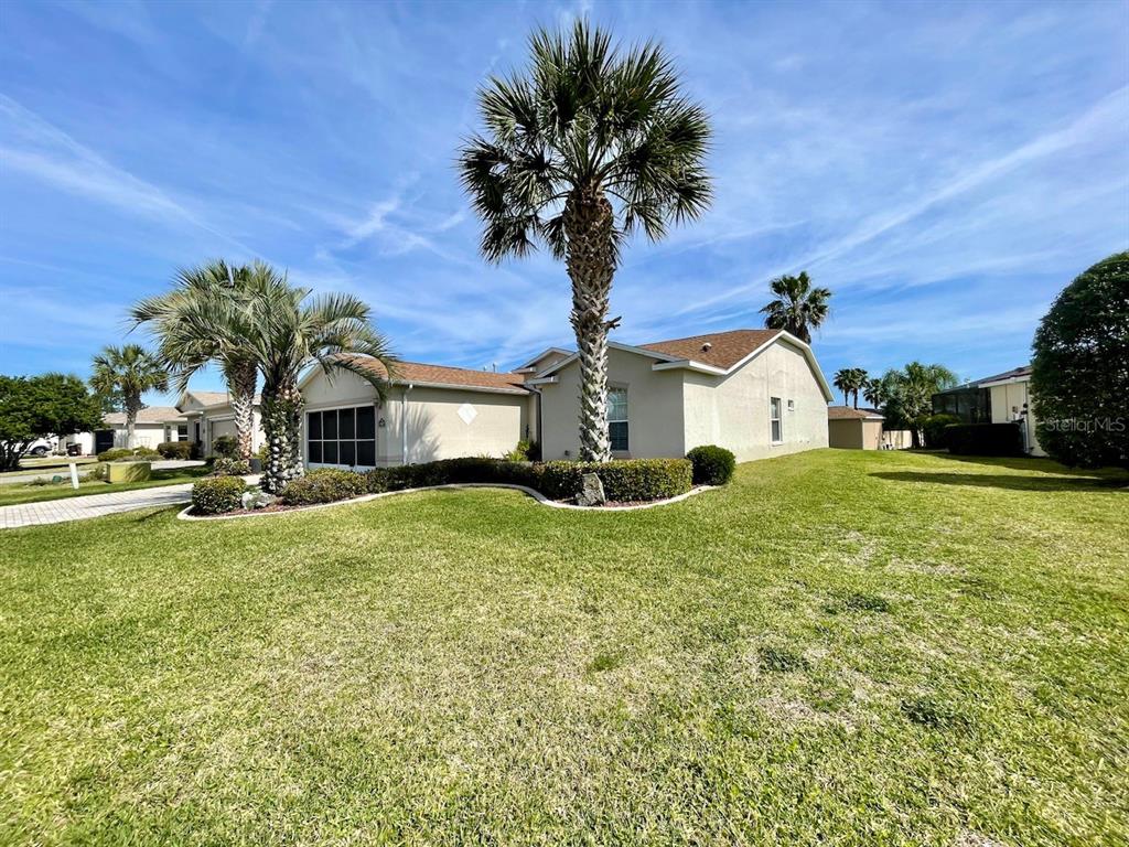 15857 Southwest 11th Terrace Road Ocala, FL 34473 - Photo 1 of 1 a front view of a house with garden