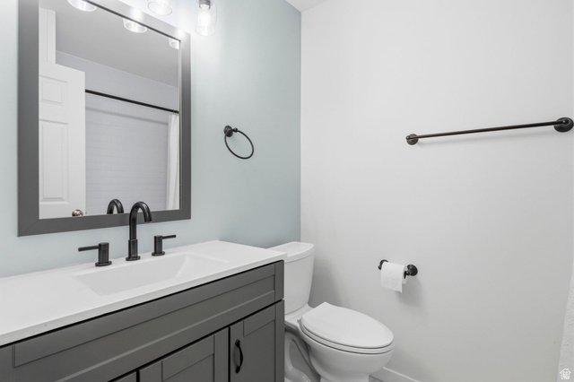 2693 Teal Way Sandy, UT 84093 - Photo 18 of 50 Bathroom featuring a gray vanity with a white countertop, undermount sink, and matte black fixtures