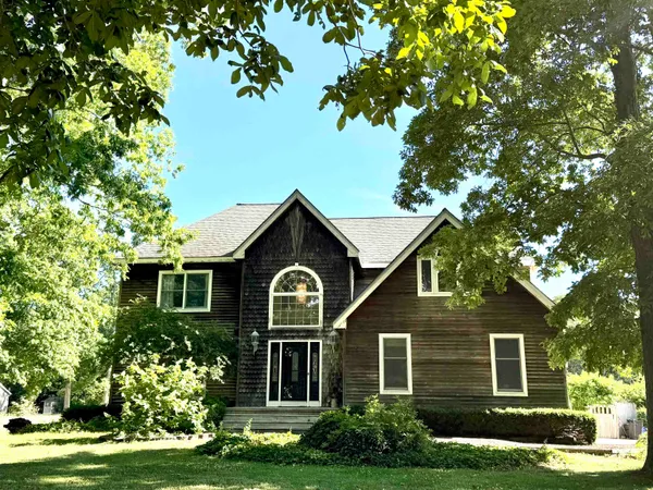 a front view of a house with a garden and plants