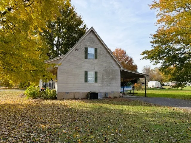 a view of an house with backyard space and garden