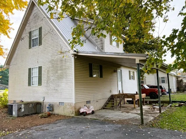 a view of a house with a patio and a fire pit