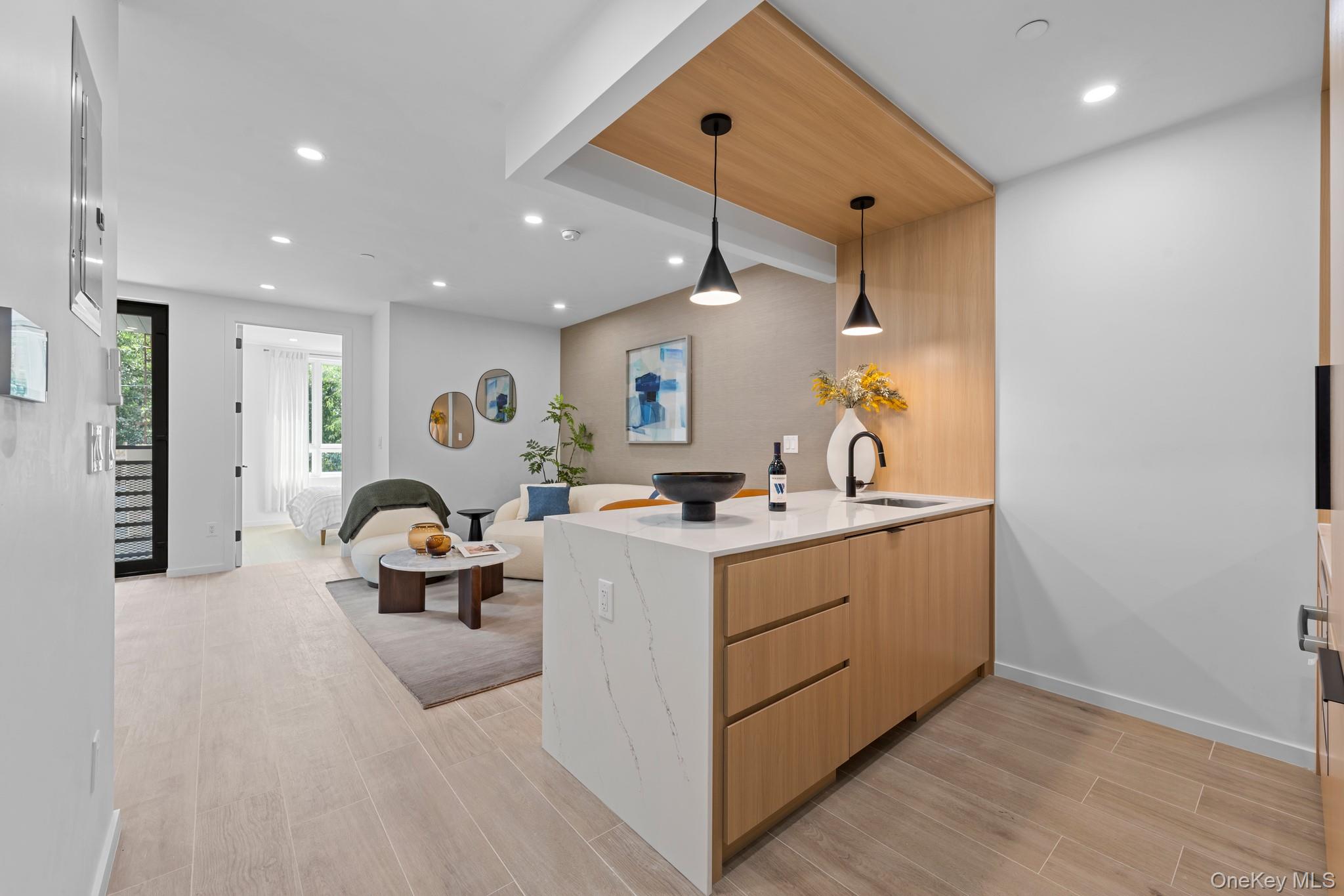 366 Harman Street, Unit 2R Brooklyn, NY 11237 - Photo 30 of 31 Kitchen with wood tiled floors, light stone countertops, a peninsula, recessed lighting, and open floor plan