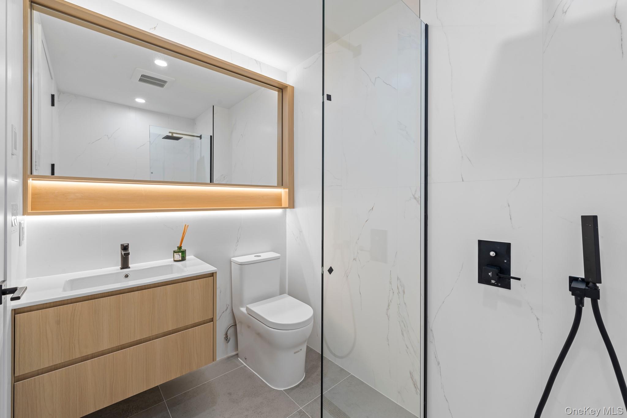 366 Harman Street, Unit 2R Brooklyn, NY 11237 - Photo 21 of 31 Bathroom featuring vanity, a marble finish shower, dark tile patterned floors, and recessed lighting