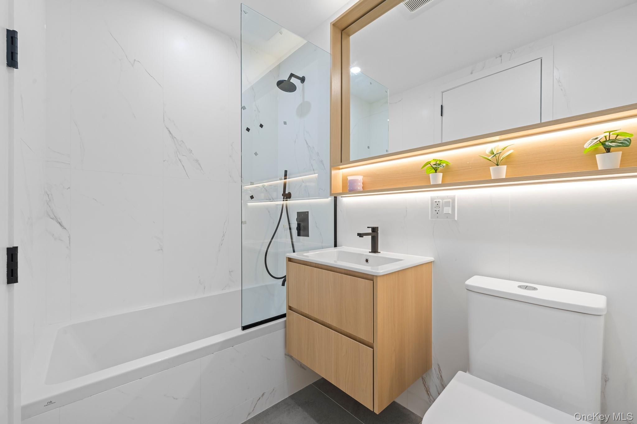 366 Harman Street, Unit 2R Brooklyn, NY 11237 - Photo 29 of 31 Full bathroom featuring a combined bath / shower with marble appearance and vanity