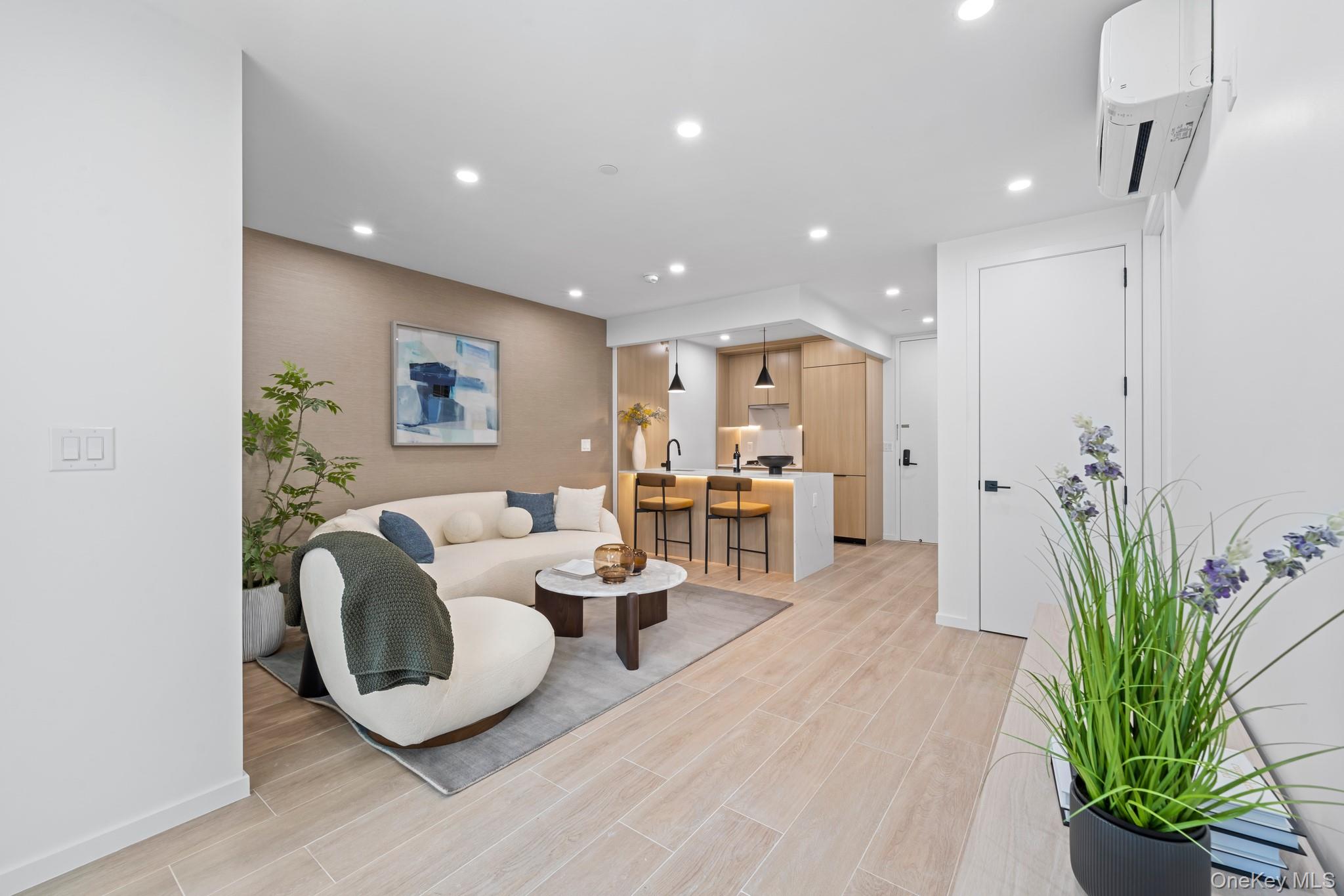 366 Harman Street, Unit 2R Brooklyn, NY 11237 - Photo 7 of 31 Living room with recessed lighting, a wall mounted AC, and wood finish floors