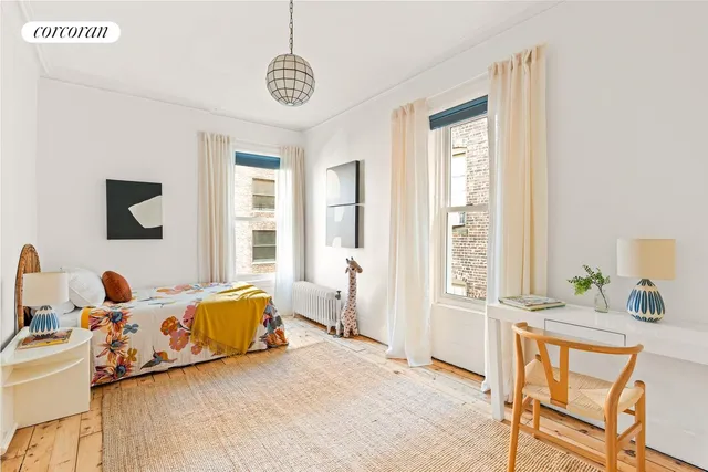 a dining room with furniture and a window