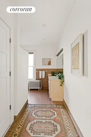 a bedroom with a bed a dresser and a window