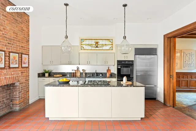 a living room with a sink a dining table and chairs with wooden floor