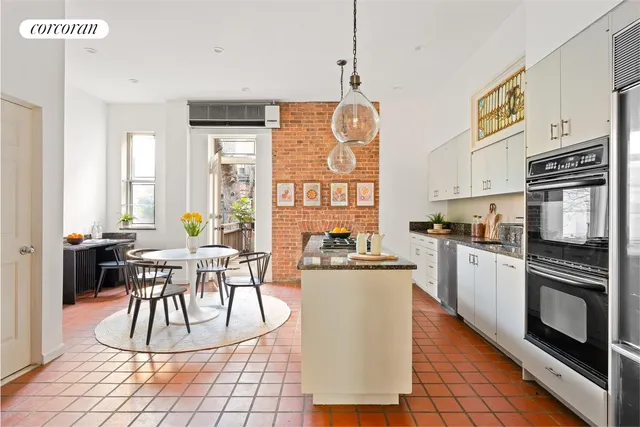 a large kitchen with stainless steel appliances kitchen island granite countertop a granite counter tops and a wooden floors