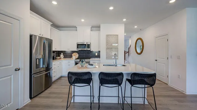 a kitchen with sink refrigerator and microwave