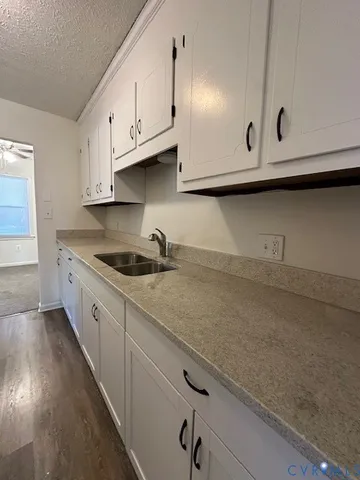 a kitchen with a stove a refrigerator and a sink