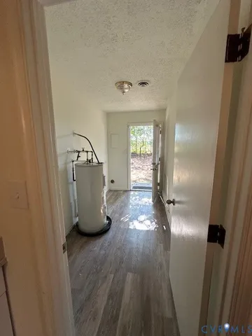 a kitchen with granite countertop stainless steel appliances a stove a sink dishwasher and cabinets with wooden floor