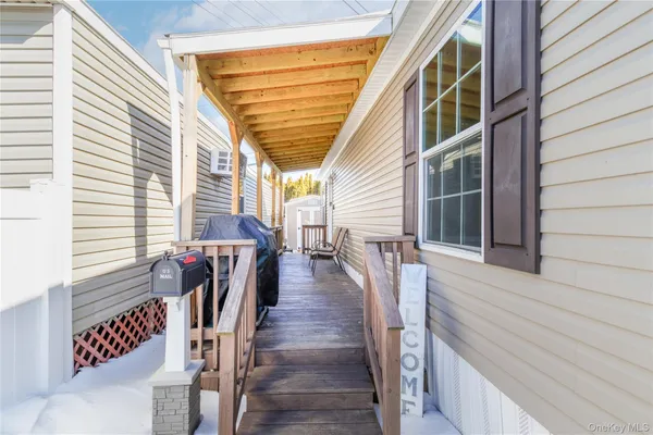 a view of a balcony with wooden floor and stairs