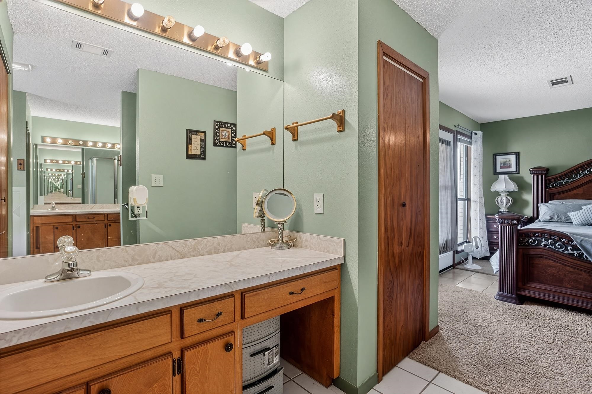 10465 Ranch To Market 1431 Buchanan Dam, TX 78609 - Photo 21 of 29 a spacious bathroom with a granite countertop sink and a mirror