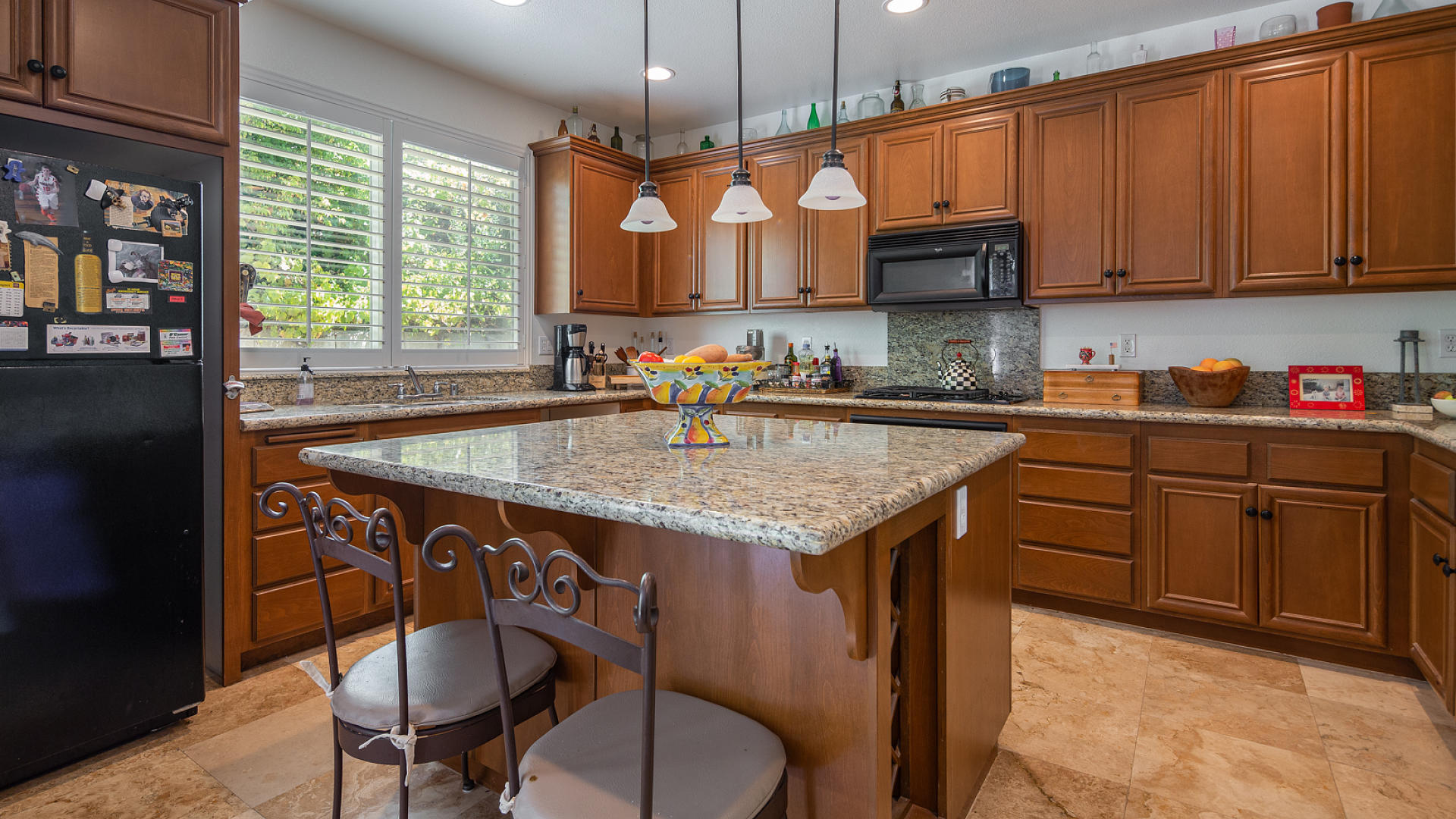 3709 Jupiter Avenue Lompoc, CA 93436 - Photo 7 of 27 a kitchen with stainless steel appliances granite countertop a sink a stove a dining table and chairs