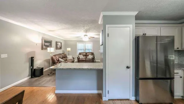 a kitchen with a refrigerator and a sink