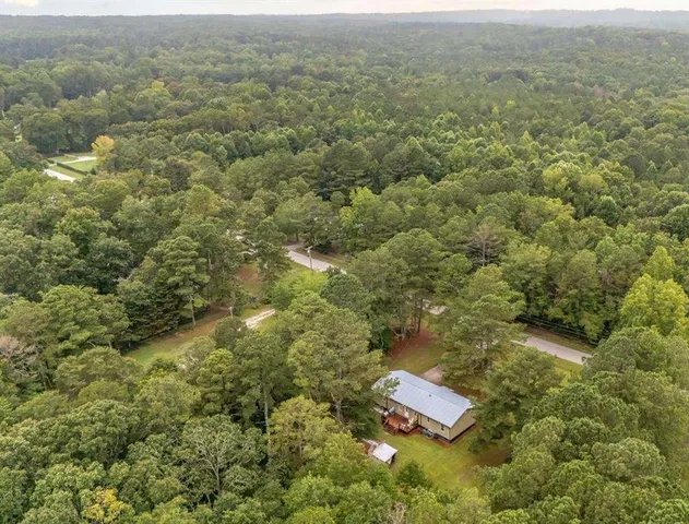 an aerial view of residential house with green space