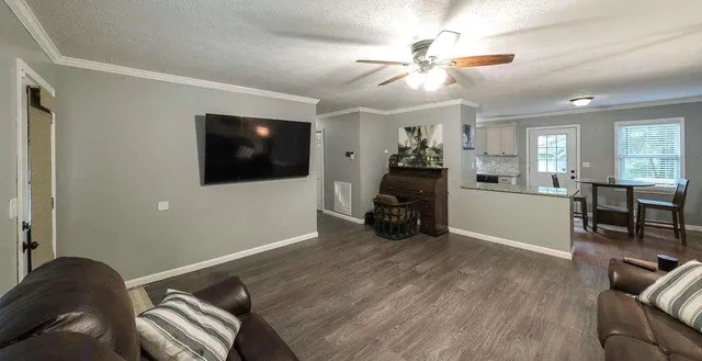 a view of a livingroom with furniture and a flat screen tv