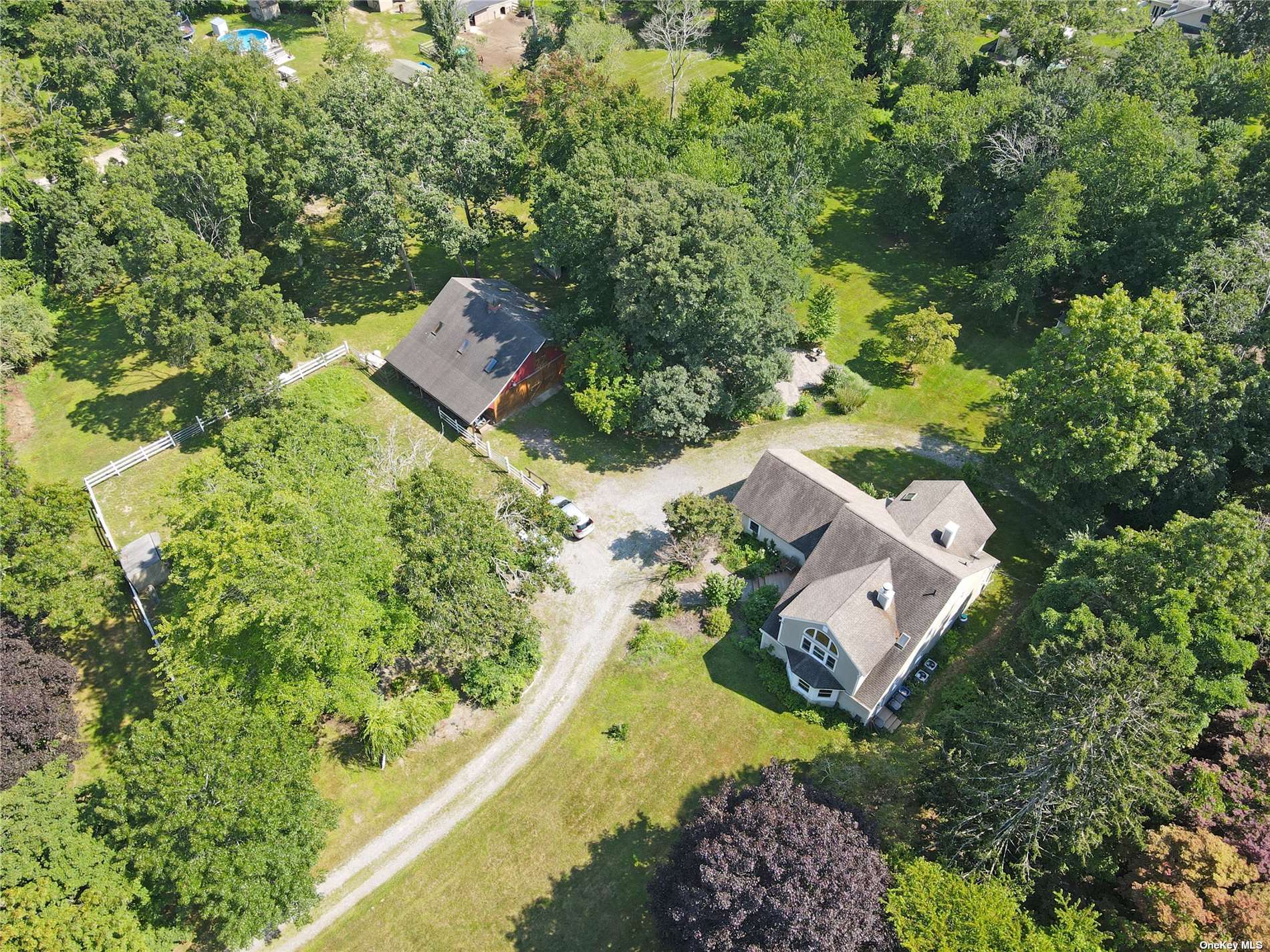 9 Peconic Road Ridge, NY 11961 - Photo 1 of 1 an aerial view of a house with a yard and a large tree