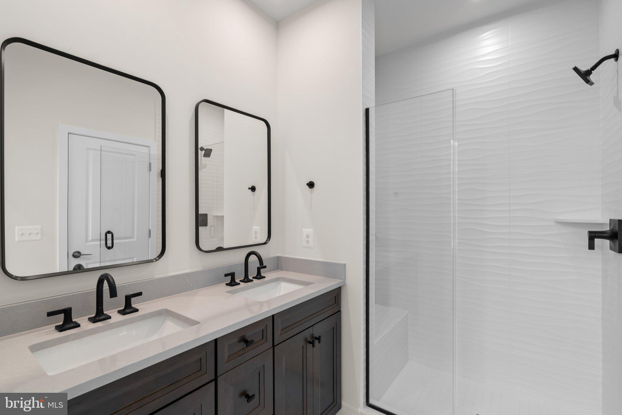 23079 Copper Tree Terrace Ashburn, VA 20148 - Photo 31 of 49 a bathroom with a double vanity sink and a mirror