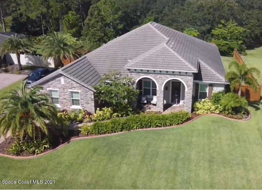 4034 Preservation Circle Melbourne, FL 32934 - Photo 1 of 25 a view of a house with a yard and potted plants