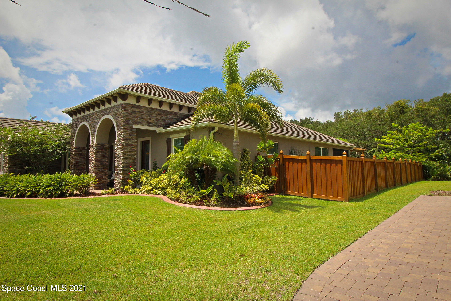 4034 Preservation Circle Melbourne, FL 32934 - Photo 2 of 25 a front view of a house with a yard